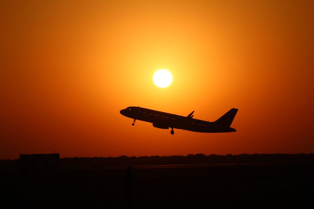British Airways Tier Point Milestone Rewards 4 Airplane taking off silhouetted against a sunset
