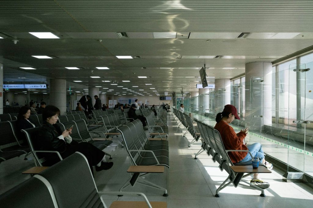 Airport terminal seating area with passengers waiting