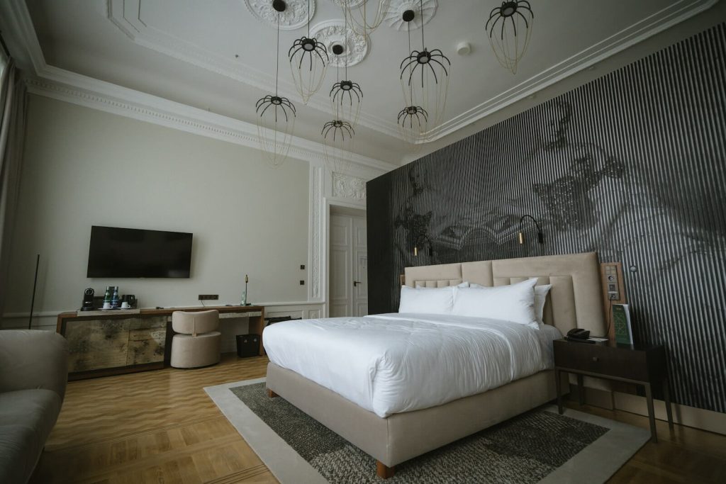 Marriott NUA vs. Suite Upgrade at Check-In 4 Elegant hotel suite bedroom with statement lighting