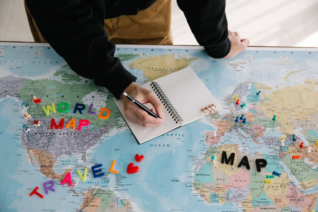 How Far in Advance Can You Book Choice Hotels With Points? 4 Person planning travel on a world map with a notebook
