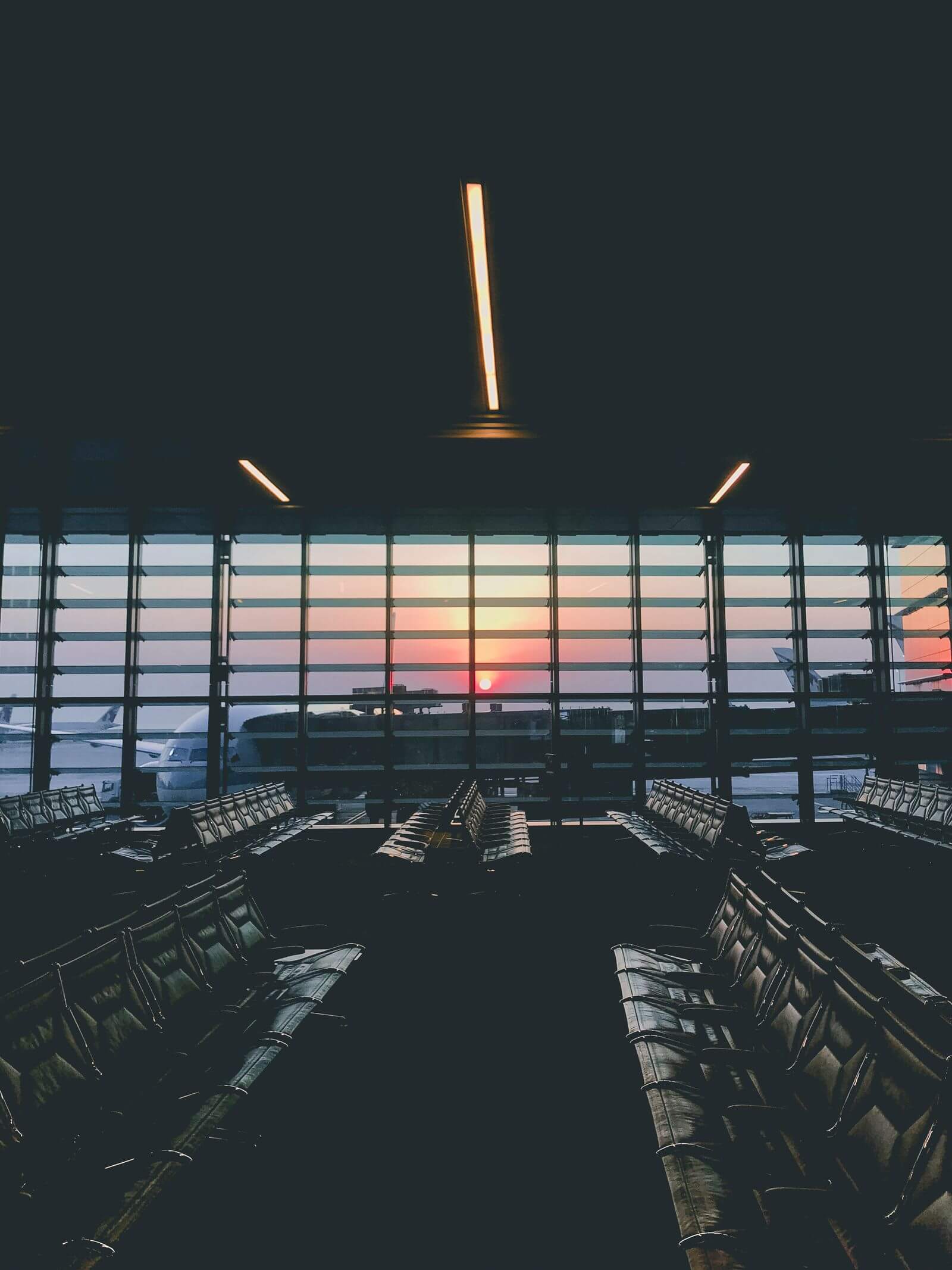 Airport terminal seating at sunset overlooking the tarmac