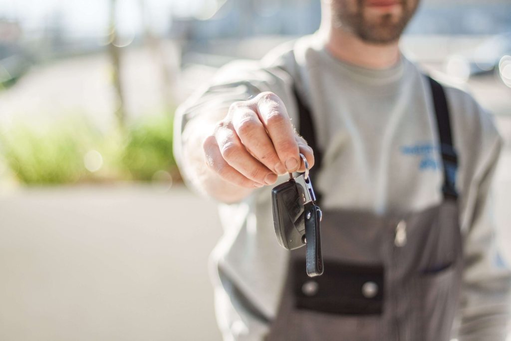 IHG Quietly Changes Its Hertz Partnership Points Structure 3 Person handing over a car rental key, representing the IHG-Hertz points partnership