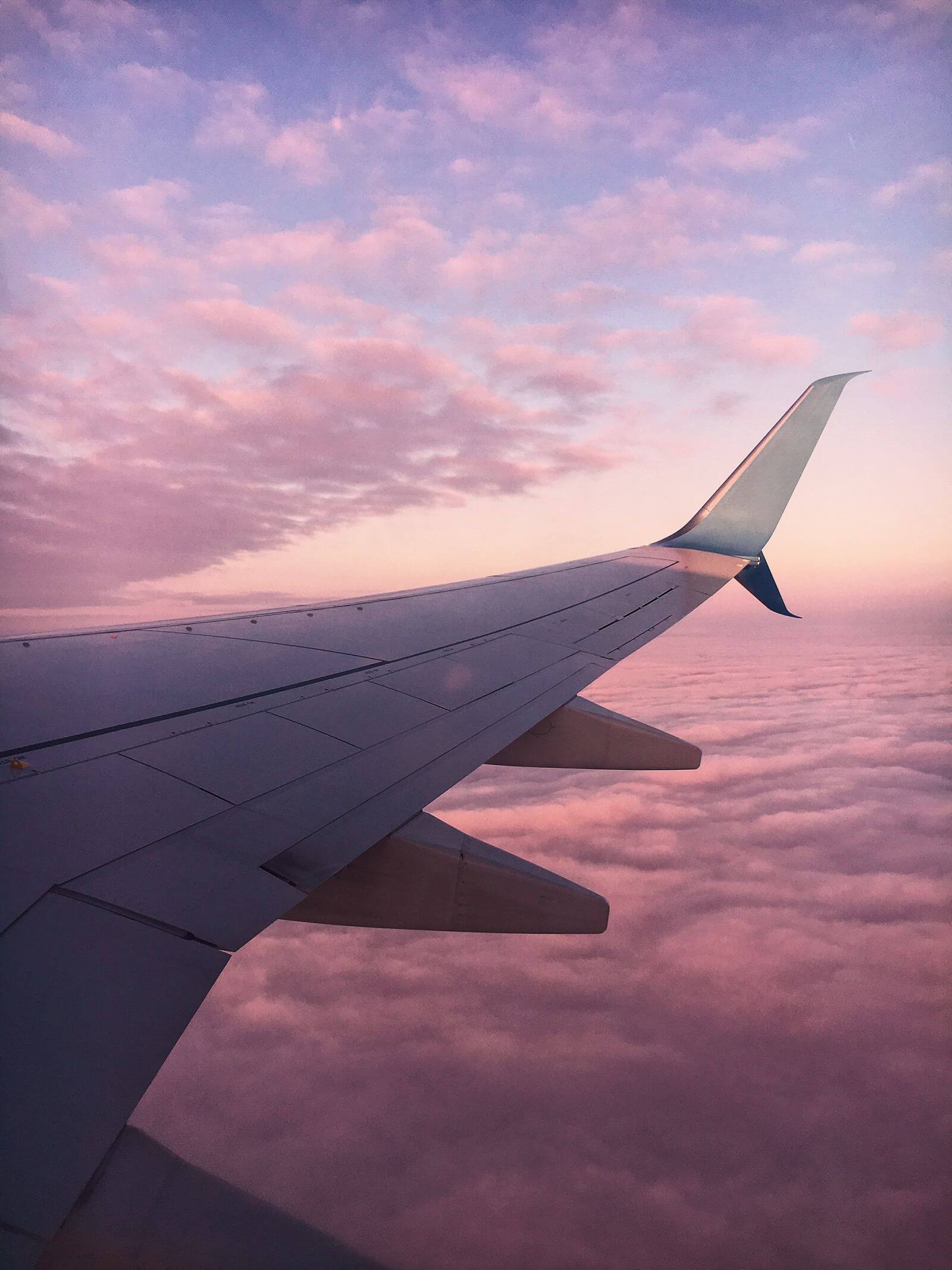 Buy Lufthansa Miles & More Miles: 50% Bonus 5 Airplane wing above clouds at sunset