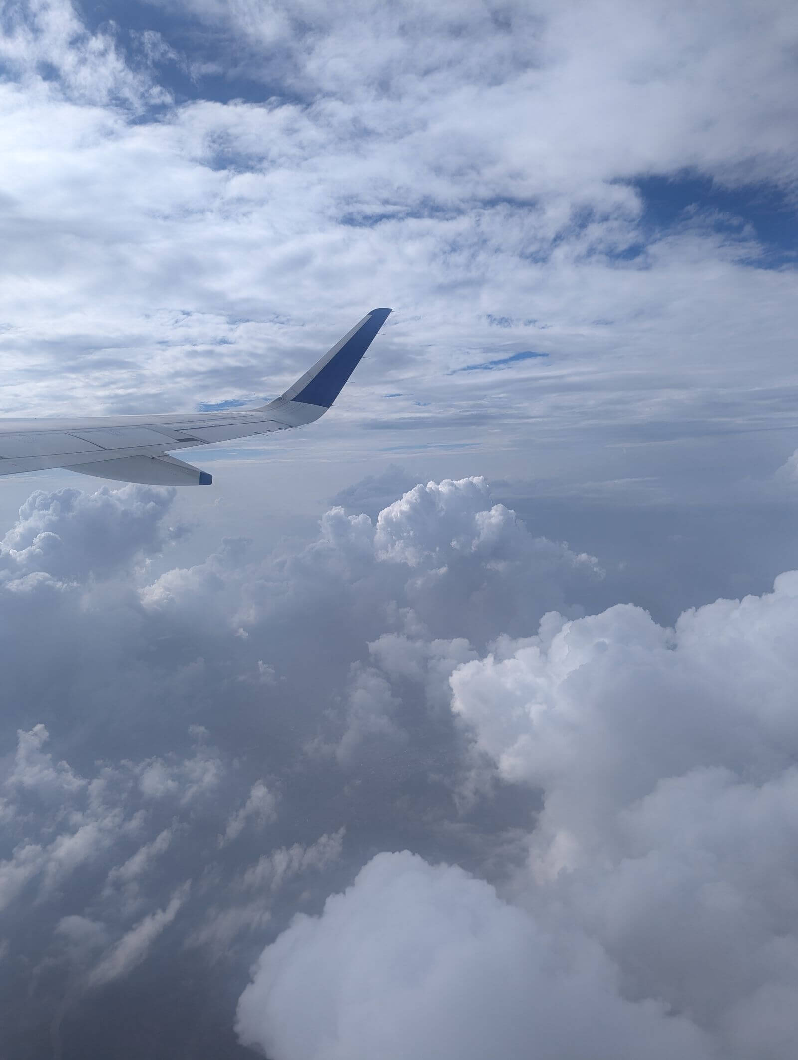 United Business Card Review: Is the $150 Fee Worth It? 3 Airplane wing above clouds during flight