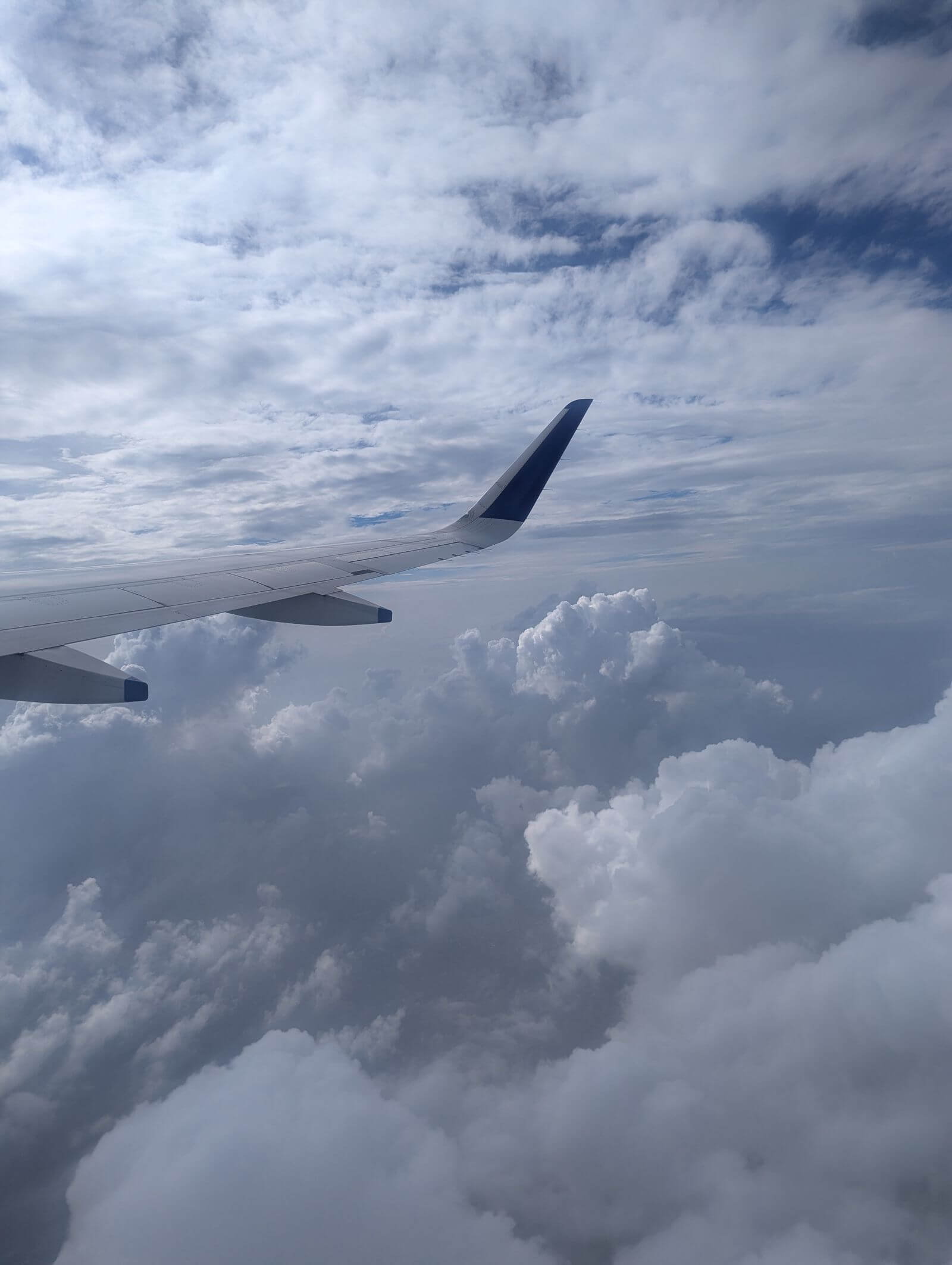 United Quest Card Review: Is the $350 Fee Worth It? 4 Airplane wing above thick clouds during flight